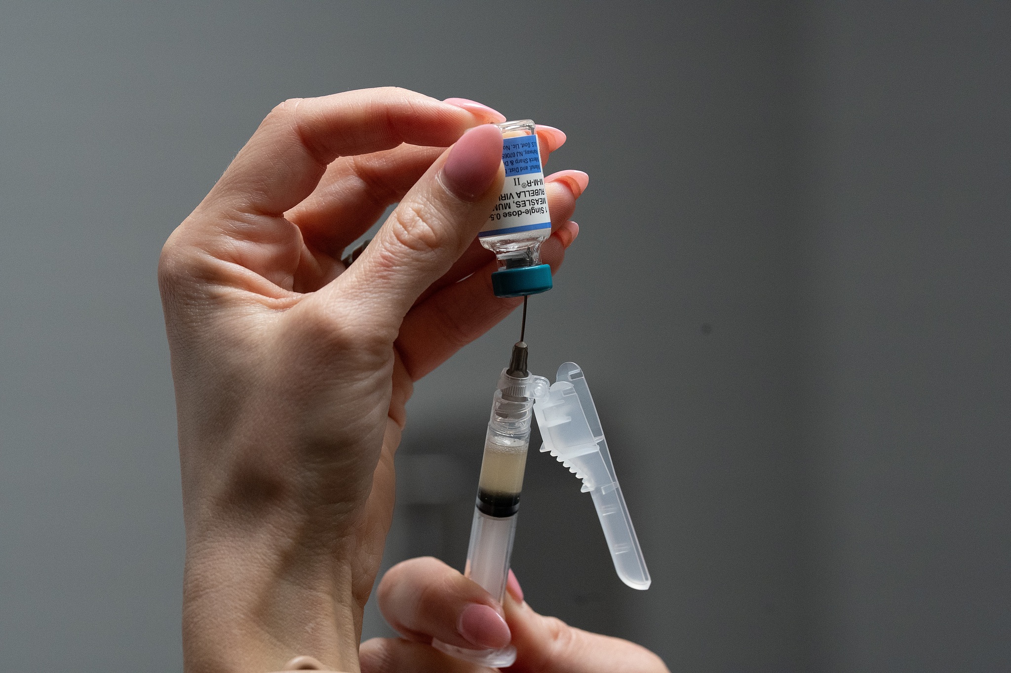 A medical assistant holds a measles, mumps and rubella (MMR) vaccine at the pediatric office of Dr. Gary M. Kramer in Coral Gables, Florida, United States, August 13, 2026. /CFP