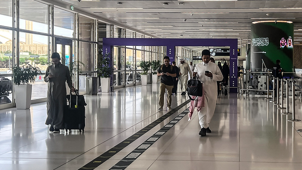 A file photo shows travelers walking through the departure terminal of King Khalid International Airport in Riyadh, Saudi Arabia, April 2, 2026. /VCG