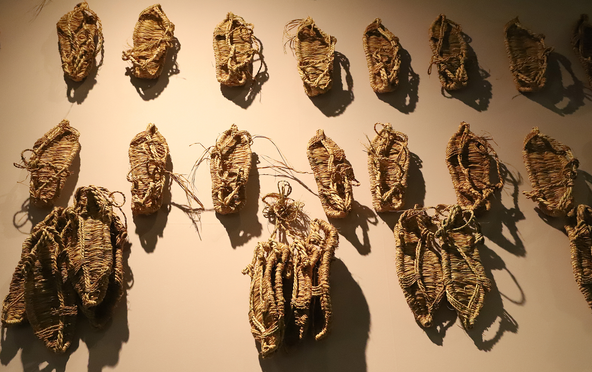 Straw sandals worn by the Red Army on display at an exhibition in the Capital Museum, Beijing, China, March 23, 2021. /CFP