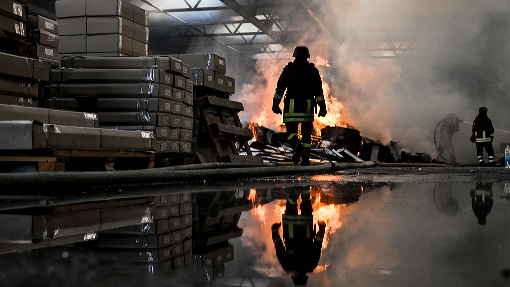 Rescuers of the State Emergency Service of Ukraine extinguish a fire in a warehouse caused by a Russian strike in Zaporizhzhia, Ukraine, October 6, 2026. /VCG