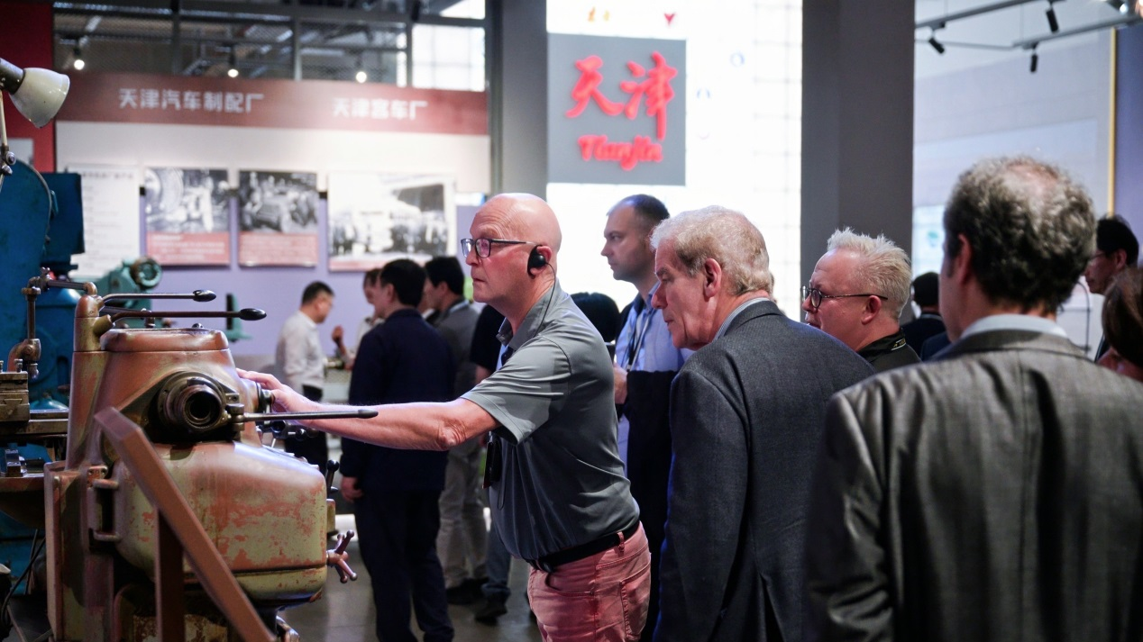 Thore Vestby, former Norwegian mayor and member of parliament, examines a machine tool exhibit at Tianjin Machine Tool Industry Museum inside Jinyi Park, October 11, 2026. 
