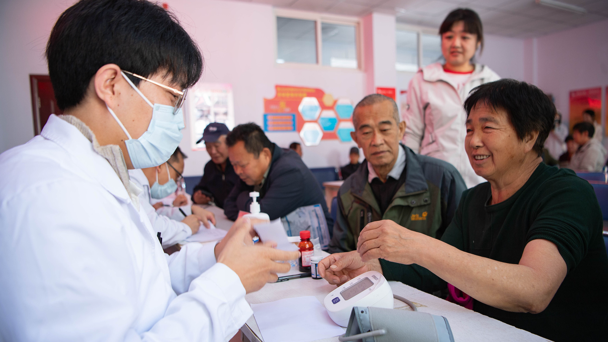 Medical experts provide free medical consultations for elderly people in Guoshan Community, Chengde, north China's Hebei Province, October 14, 2026. /VCG
