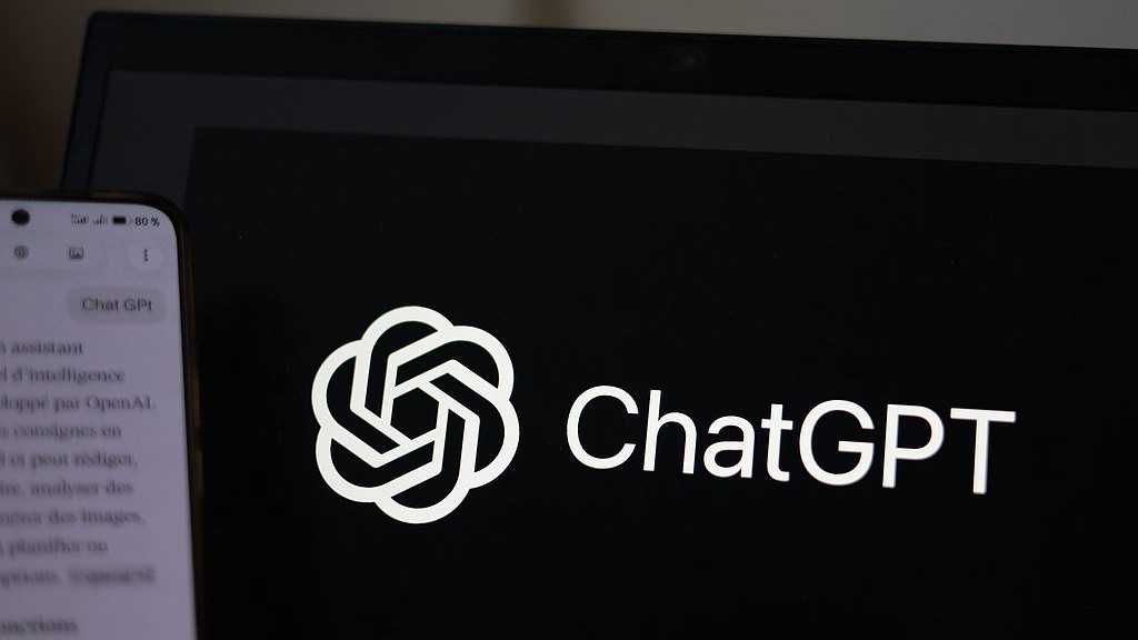 OpenAI's ChatGPT chatbot on a smartphone in front of a computer screen showing ChatGPT logo. /VCG