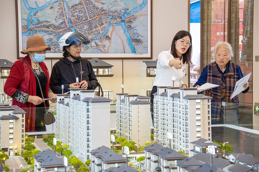 Visitors check home layouts and community amenities at a property sales model in Hai'an, Jiangsu Province, October 1, 2026. /VCG