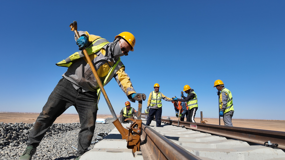Workers build a 950-kilometer desert heavy-haul railway in Algeria, which entered full operation in February, 2026. A 575-kilometer section was built by China Railway Construction Corporation and an Algerian state-owned company. /China Railway Construction Corporation