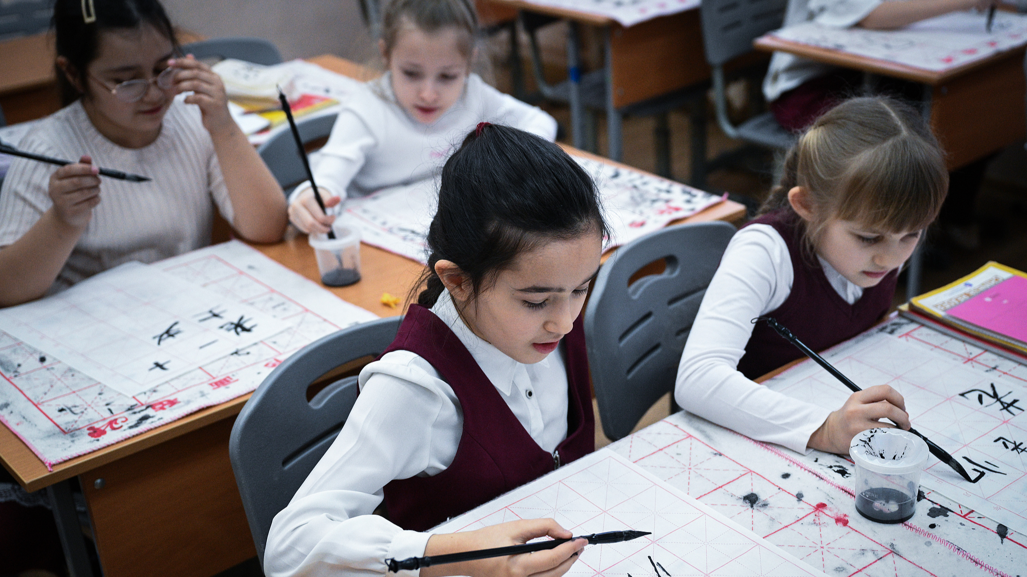 Pupils learn to write Chinese characters during a Chinese language class at a school in Moscow, Russia, February 14, 2025. /VCG