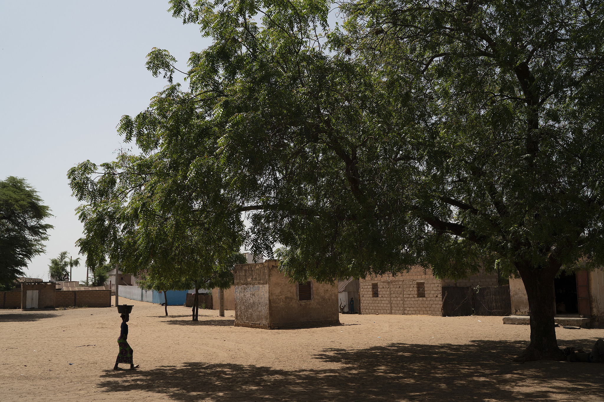 A girl carries a bucket of water from a community well in the village of Ndiawagne Fall in Kebemer, Senegal, November 5, 2021. The region is on one end of the 