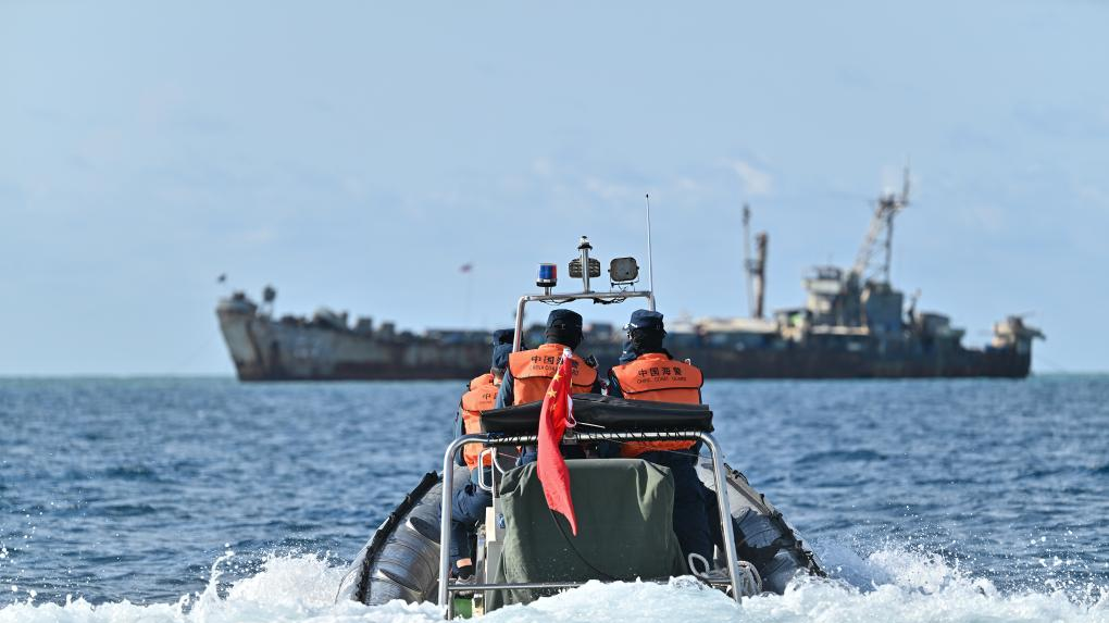 File photo of law enforcers of China Coast Guard inspecting near an illegally 