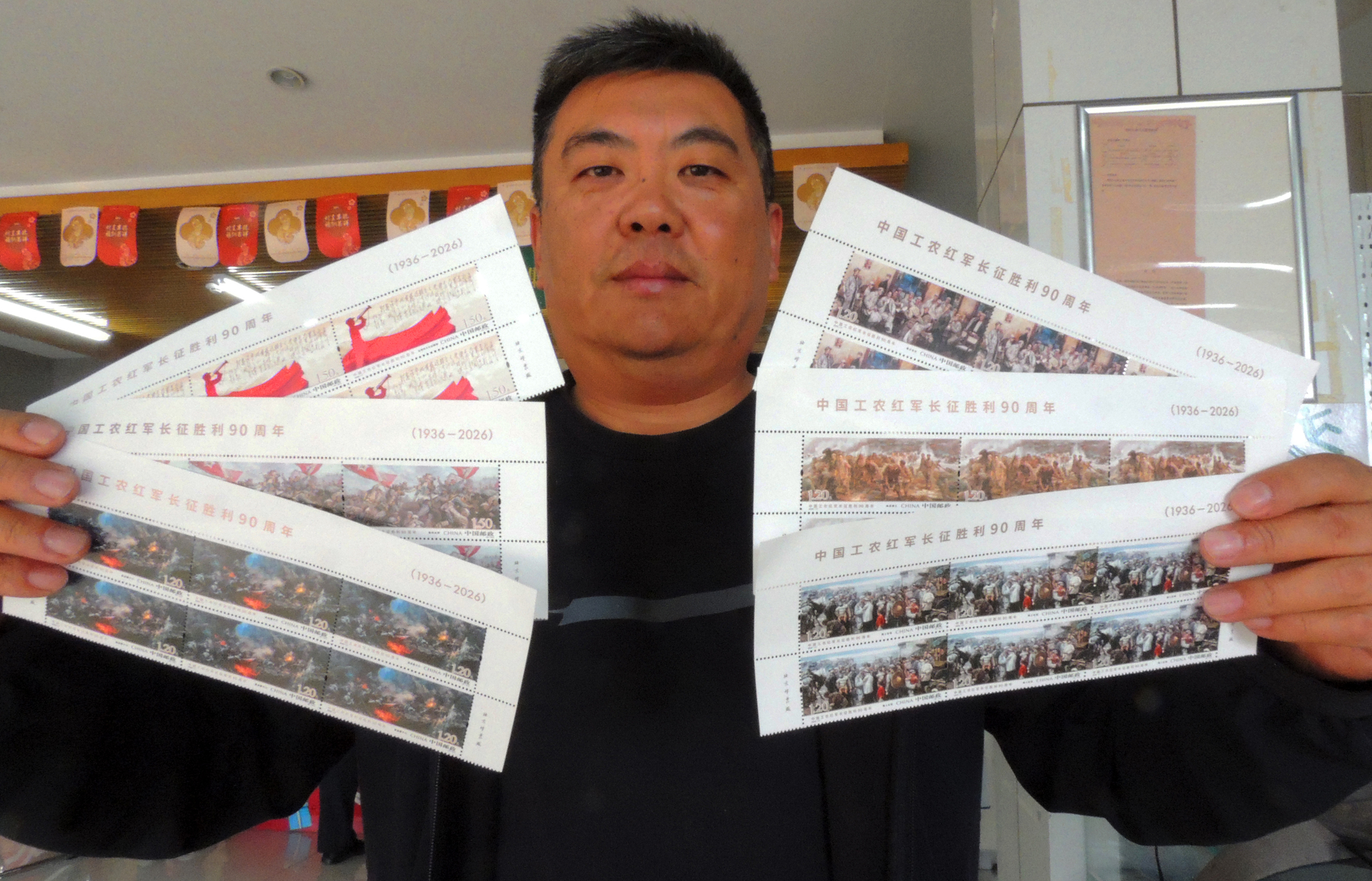 A buyer shows off the set of newly issued commemorative stamps purchased at the China Philately shop in Lianyungang, east China's Jiangsu Province, on October 22, 2026. /VCG 