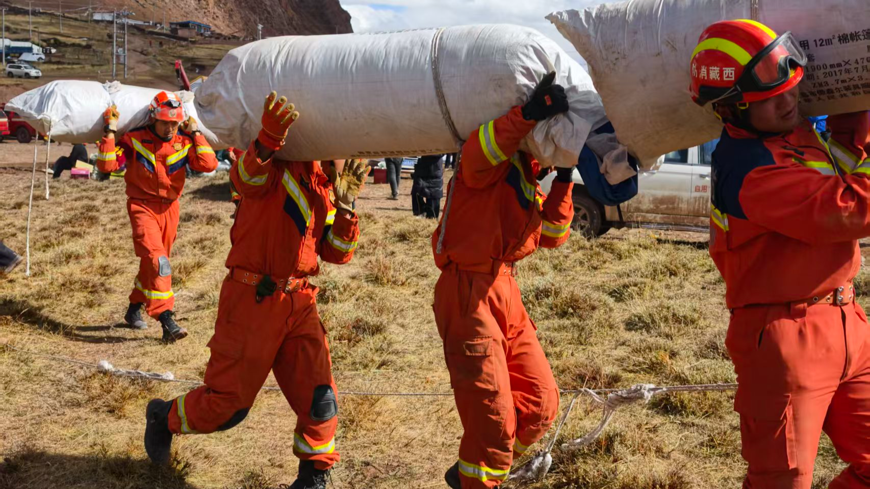 Firefighters help distribute relief supplies and set up tents for displaced residents in disaster-hit areas in the city of Nagqu, southwest China's Xizang Autonomous Region, October 23, 2026. /The Xizang fire and rescue corps