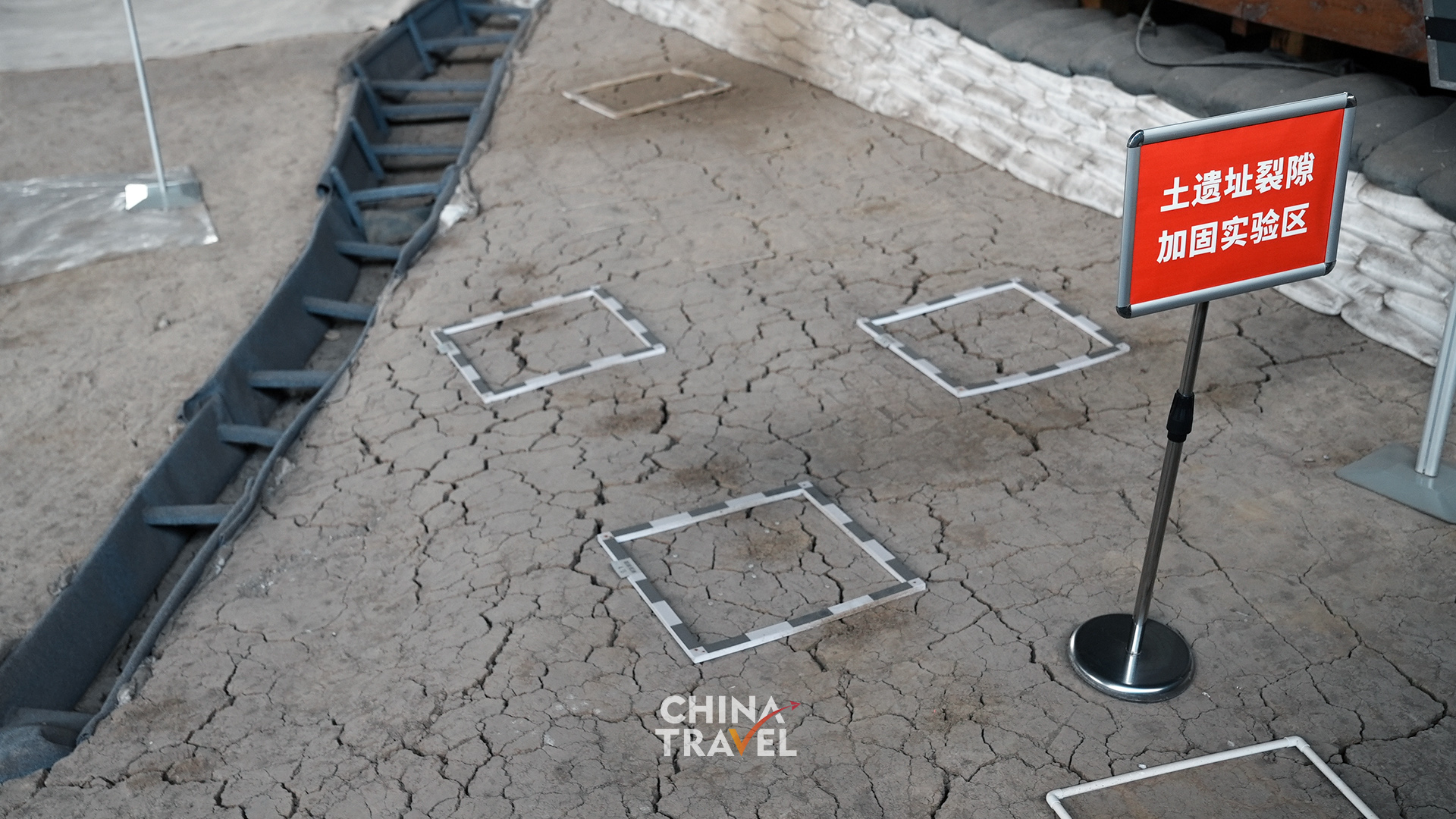 Marked test areas on the exposed earth highlight the careful work of studying and protecting the site itself. /CGTN
