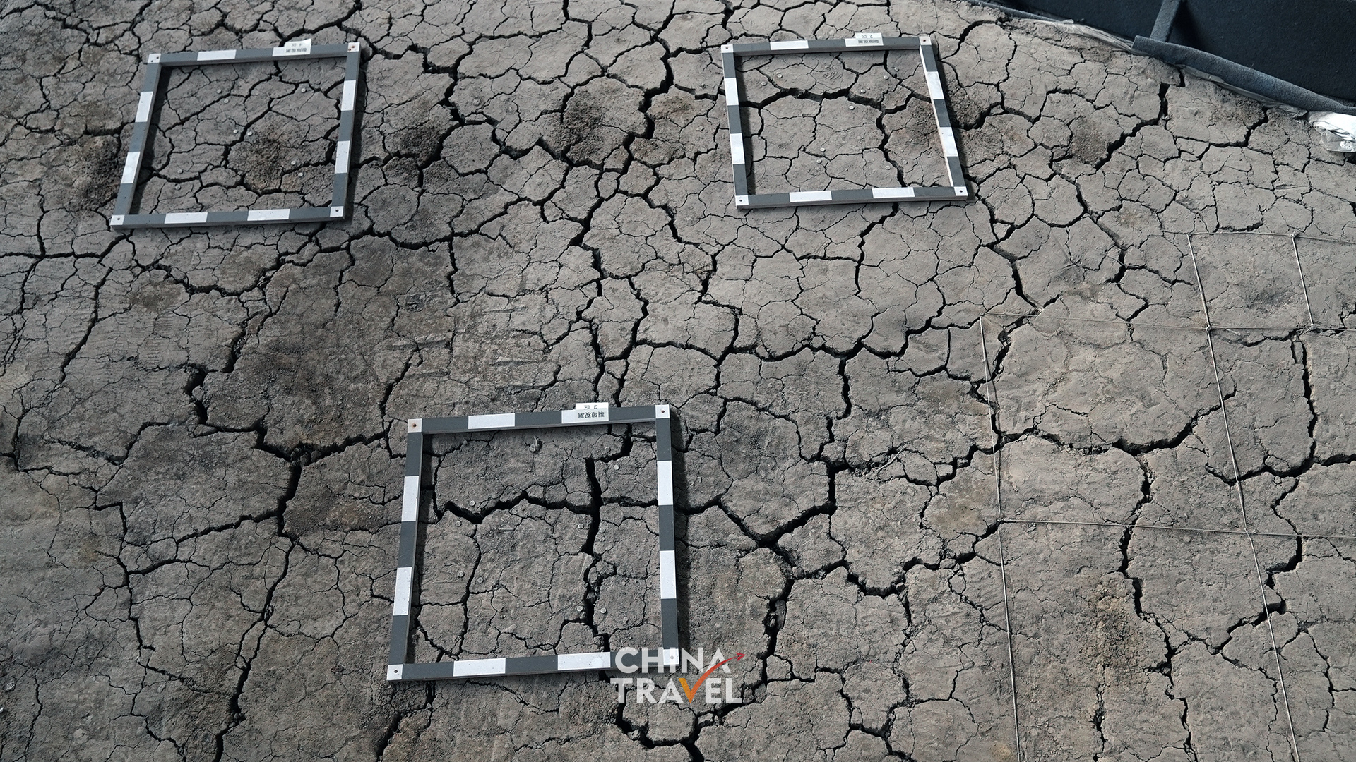 Marked test areas on the exposed earth highlight the careful work of studying and protecting the site itself. /CGTN