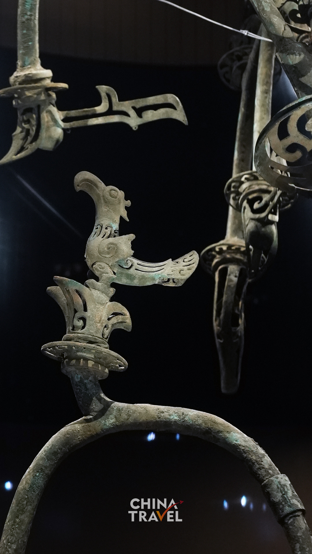 Perched birds and curling branches turn the tree's upper levels into an intricate sculptural world.
