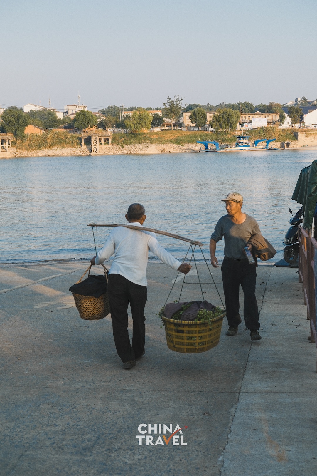 Boats, riverside greenery and people by the landing offer glimpses of an autumn day along the water. /CGTN
