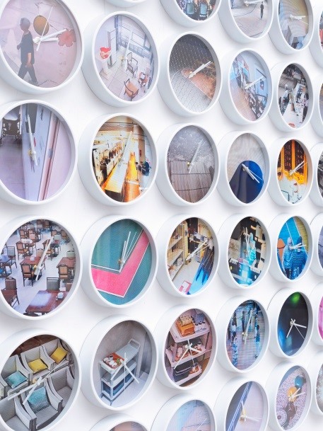 Rows of clocks inlaid with photos taken by photographer Zhang Xiao in southwest China's Chengdu hang on the walls of a hall in Beijing's Taikang Art Museum, forming the artwork 