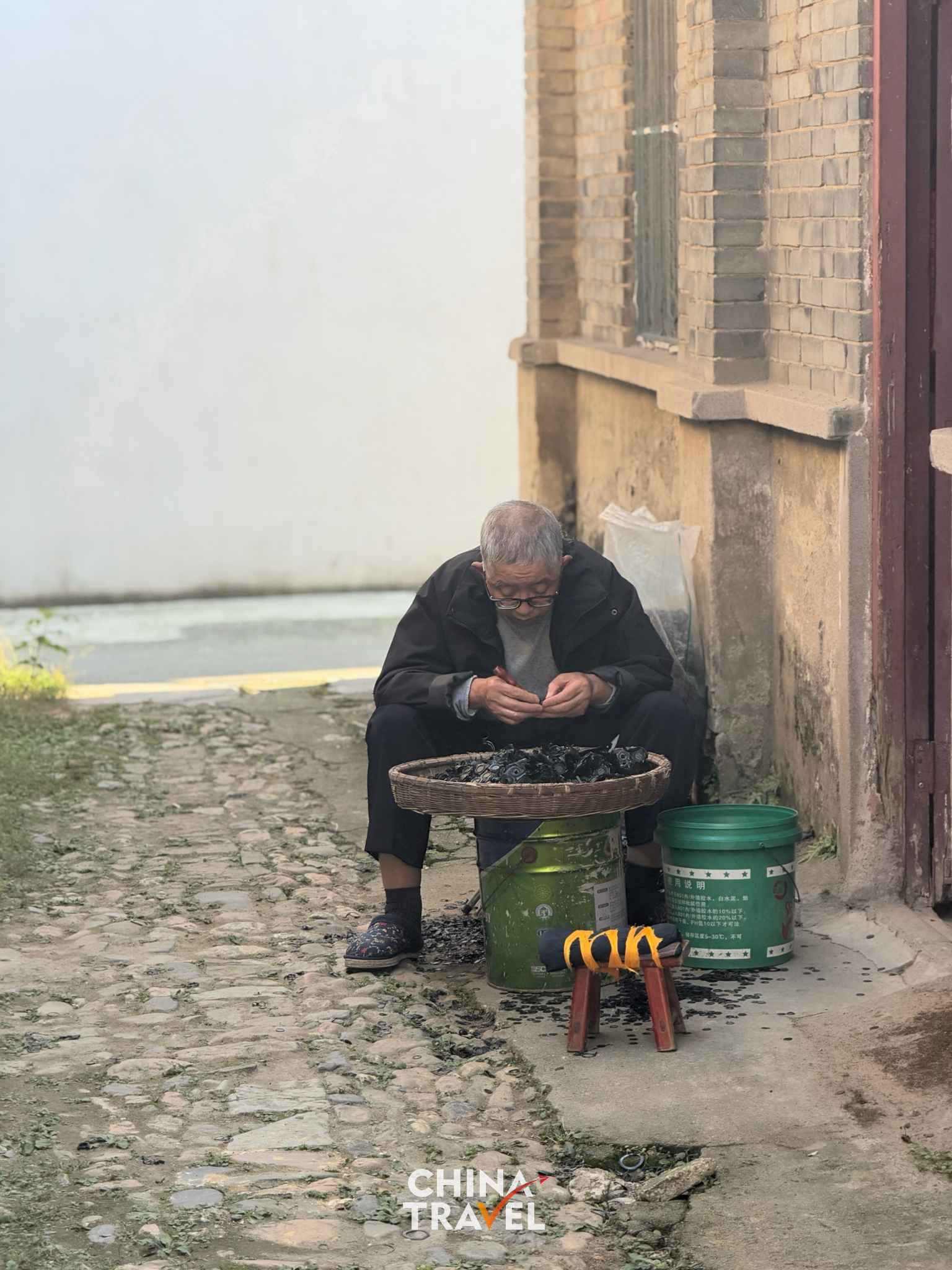 An elderly resident enjoying a quiet afternoon outside their home. /CGTN