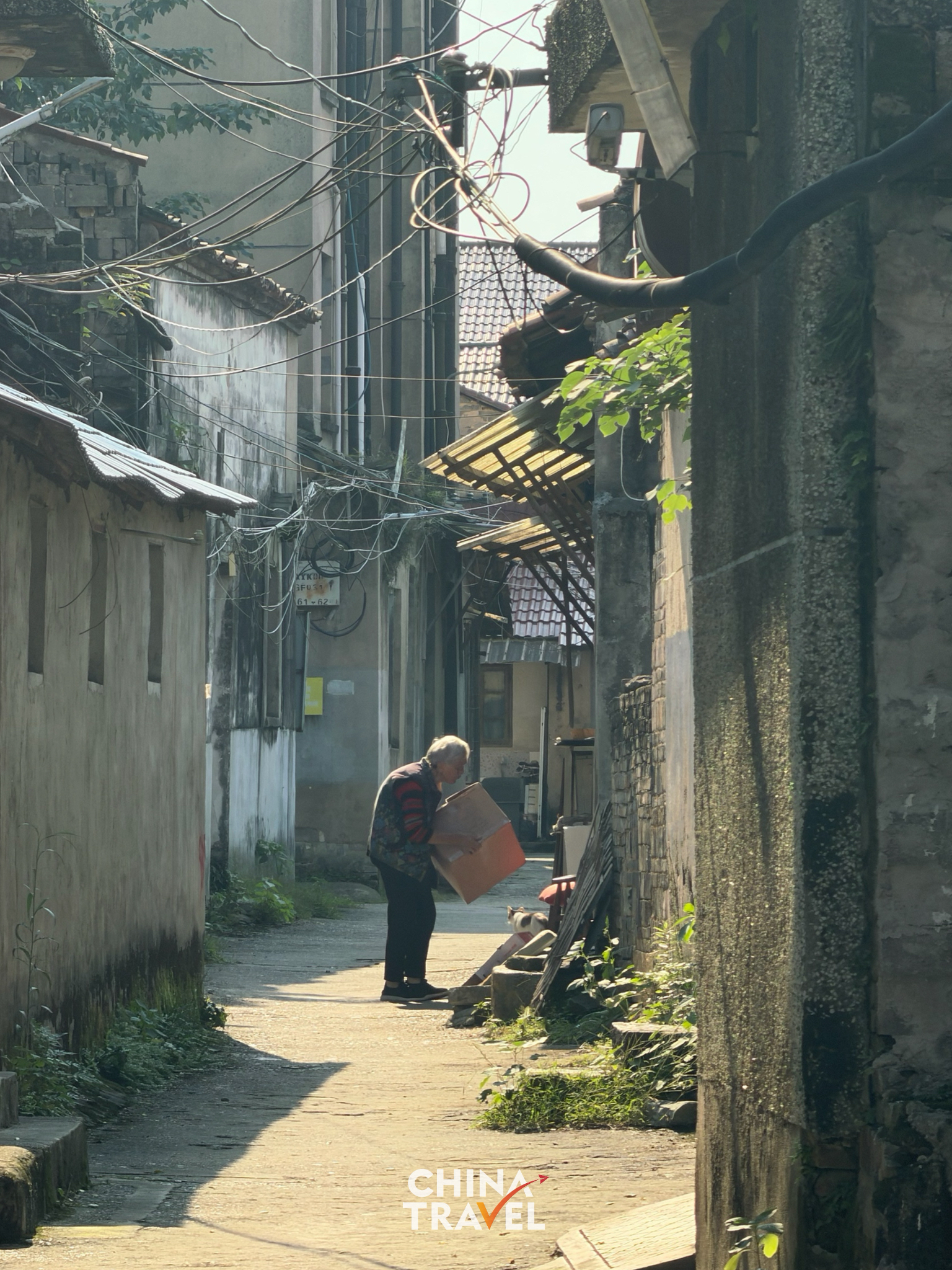 An elderly resident enjoying a quiet afternoon outside their home. /CGTN
