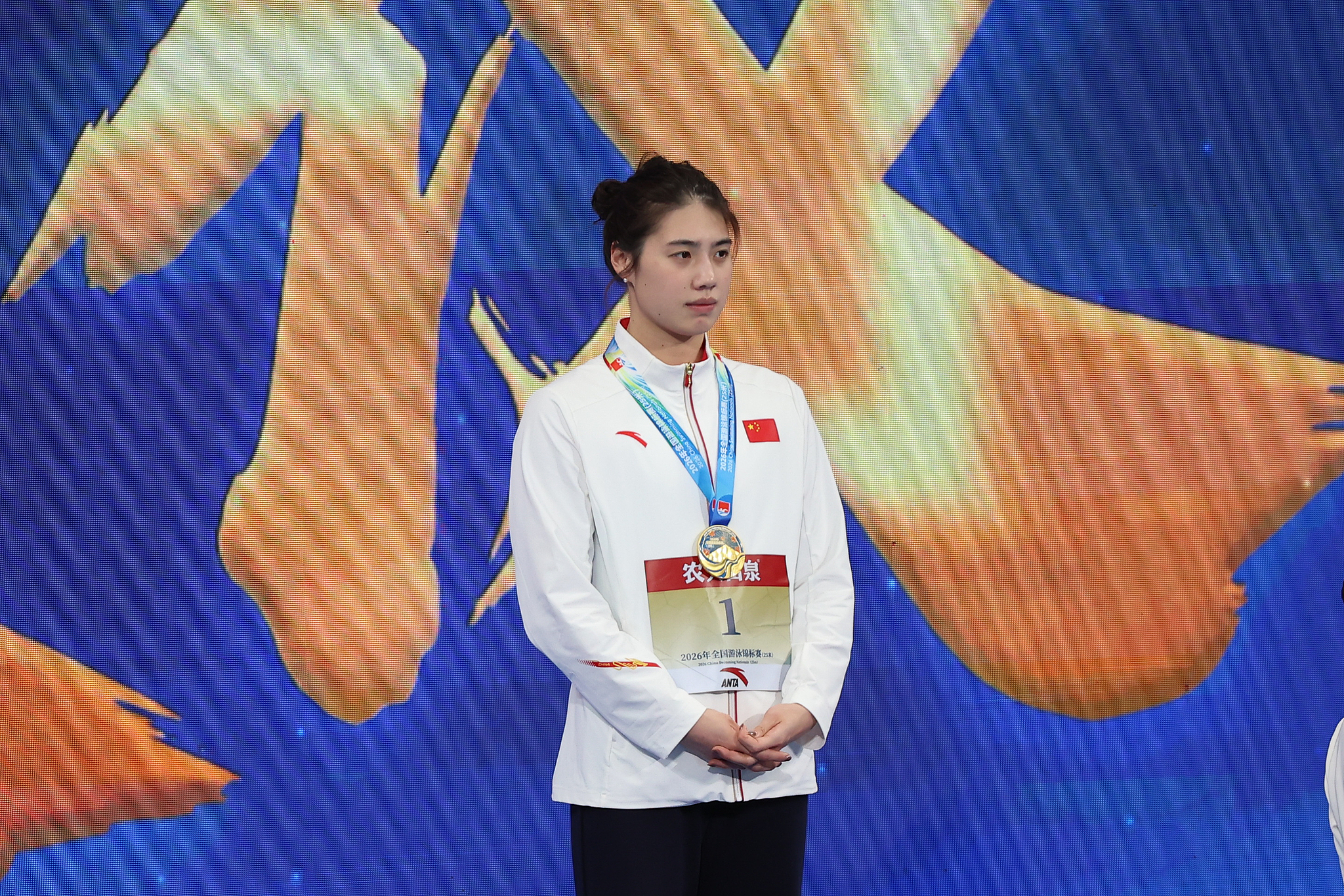 China's Zhang Yufei poses with the women's 100m butterfly gold medal after breaking the Asian record in 54.87 seconds en route to winning the final at the National Swimming Championships (25m) in Beijing, October 27, 2026. /VCG