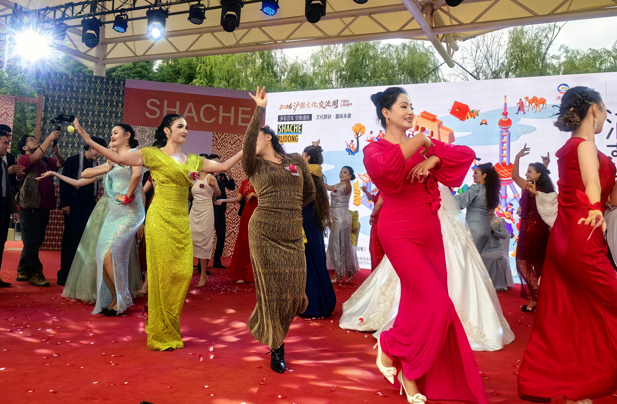 People dance and sing during the 2026 Shanghai-Xinjiang Cultural Exchange Week event in Zhoupu Town, Shanghai on October 29, 2026. /VCG