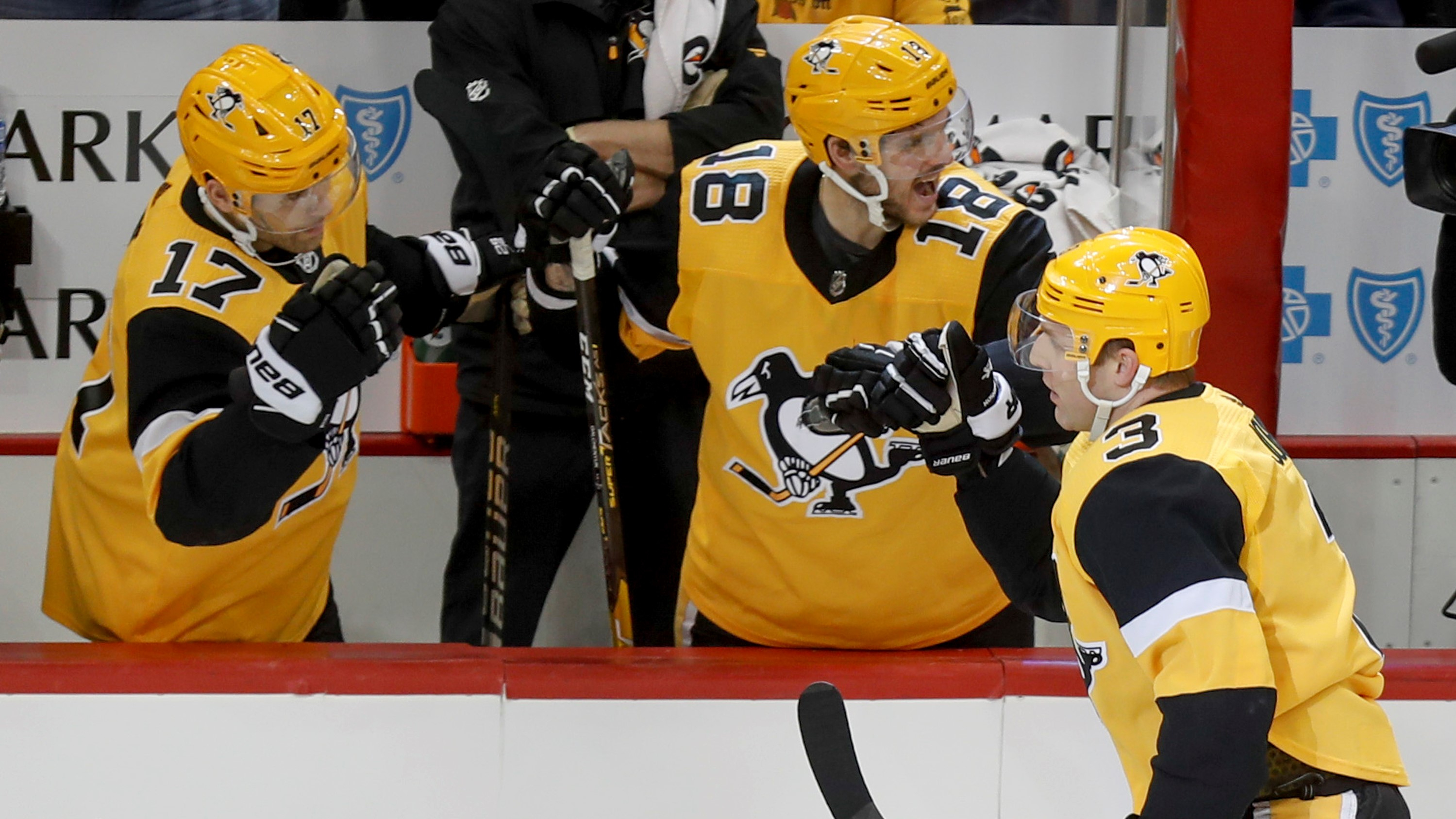 Pittsburgh Penguins' Bryan Rust (17) celebrates his goal with Jake
