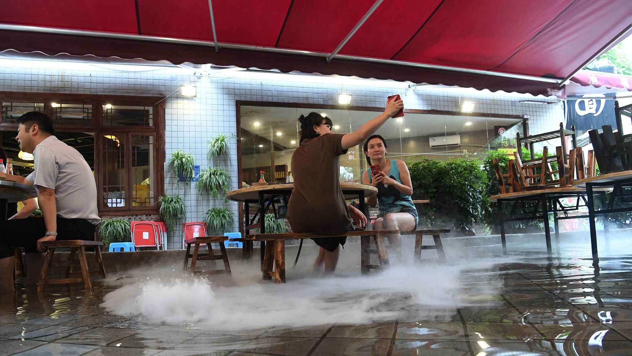 Food in hot pot, feet in cool water at restaurant in SW China CGTN