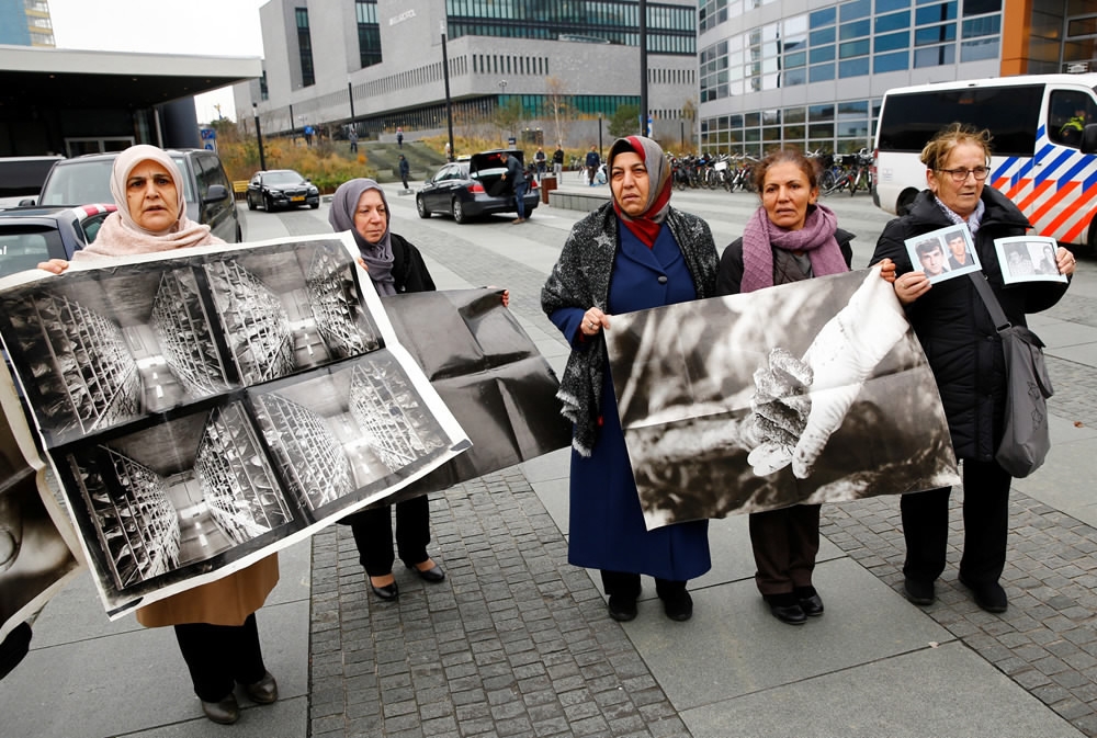Mothers of victims pose with photos during the trial of former Bosnian Serb...